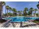 Community pool with clear blue water, palm trees, and inviting lounge areas perfect for relaxation and recreation at 14975 Renaissance Ave, Odessa, FL 33556