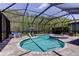 Beautiful pool and spa surrounded by lush landscaping within the screened enclosure at 14975 Renaissance Ave, Odessa, FL 33556