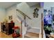 Carpeted staircase with white railings and wood trim, complemented by elegant decor and an adjacent fish tank at 14975 Renaissance Ave, Odessa, FL 33556