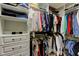 This walk-in closet offers ample storage space with custom shelving and drawers at 14975 Renaissance Ave, Odessa, FL 33556