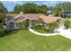 Aerial view of a single-Gathering home with large yard, mature trees and in ground pool at 1551 Mcauliffe Ln, Palm Harbor, FL 34683