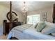 This is a calming bedroom with a beautifully decorated four-poster bed and soft lighting at 1551 Mcauliffe Ln, Palm Harbor, FL 34683