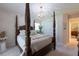 Comfortable bedroom featuring a decorative four-poster bed, neutral tones, and ample natural light at 1551 Mcauliffe Ln, Palm Harbor, FL 34683