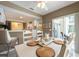 Dining area overlooking kitchen and lanai with pool view at 1551 Mcauliffe Ln, Palm Harbor, FL 34683