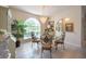 Elegant dining room featuring a chandelier, archways and large window at 1551 Mcauliffe Ln, Palm Harbor, FL 34683