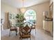 Elegant dining room features a glass table with decorative chairs and chandelier, creating a welcoming ambiance at 1551 Mcauliffe Ln, Palm Harbor, FL 34683