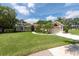 Well-maintained home with a landscaped lawn, mature trees and a two-car garage at 1551 Mcauliffe Ln, Palm Harbor, FL 34683