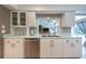 Bright white kitchen with stainless appliances, tile floors, and eat in nook at 1551 Mcauliffe Ln, Palm Harbor, FL 34683