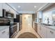 Bright white kitchen with stainless appliances, tile floors, and eat in nook at 1551 Mcauliffe Ln, Palm Harbor, FL 34683