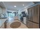 Bright white kitchen with stainless appliances, tile floors, and eat in nook at 1551 Mcauliffe Ln, Palm Harbor, FL 34683