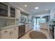 Bright white kitchen with stainless appliances, tile floors, and eat in nook at 1551 Mcauliffe Ln, Palm Harbor, FL 34683
