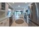 Bright white kitchen with stainless appliances, tile floors, and eat in nook at 1551 Mcauliffe Ln, Palm Harbor, FL 34683