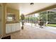 Covered lanai with outdoor kitchen and bar perfect for outdoor relaxation and entertainment at 1551 Mcauliffe Ln, Palm Harbor, FL 34683