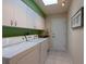 Functional laundry room with modern washer and dryer, tiled floor, and extra storage cabinets at 1551 Mcauliffe Ln, Palm Harbor, FL 34683