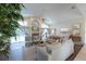 Open-concept living room featuring vaulted ceilings, elegant furnishings, and direct access to the outdoor pool area at 1551 Mcauliffe Ln, Palm Harbor, FL 34683