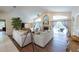 Cozy living room with fireplace, vaulted ceilings, wood floors, and access to pool, perfect for entertaining at 1551 Mcauliffe Ln, Palm Harbor, FL 34683