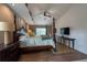 This is a well-lit main bedroom boasting a four-poster bed and a mounted television for relaxing evenings at 1551 Mcauliffe Ln, Palm Harbor, FL 34683