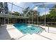 Sparkling screened-in pool with a beautiful backyard view provides a refreshing oasis at 1551 Mcauliffe Ln, Palm Harbor, FL 34683
