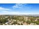 Expansive aerial view of a neighborhood with water and city skyline in the background under a blue sky with scattered clouds at 1625 Fulton Ave, Clearwater, FL 33755