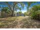 Expansive backyard featuring mature trees and a privacy fence, perfect for outdoor entertaining at 1625 Fulton Ave, Clearwater, FL 33755