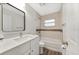 Bright bathroom featuring a modern vanity, stylish mirror, and a shower-tub combination at 1625 Fulton Ave, Clearwater, FL 33755