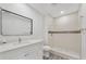 Bathroom with gray floors, white vanity, shower, and a sleek mirror at 1625 Fulton Ave, Clearwater, FL 33755