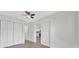 A bedroom featuring gray floors, white walls, closet, and a view into the bright kitchen at 1625 Fulton Ave, Clearwater, FL 33755