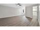 Spacious bedroom with wood-look floors and ceiling fan, adjacent to desk area and bathroom at 1625 Fulton Ave, Clearwater, FL 33755
