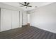 This bedroom features gray floors, two large closets, and a ceiling fan for added comfort at 1625 Fulton Ave, Clearwater, FL 33755