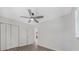 The bright bedroom features gray floors, closet, and a view into the bright kitchen at 1625 Fulton Ave, Clearwater, FL 33755