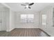 Well-lit bedroom showcasing a ceiling fan, window, and door leading to a backyard at 1625 Fulton Ave, Clearwater, FL 33755