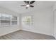A bedroom with modern gray floors, white walls, and natural light from two windows at 1625 Fulton Ave, Clearwater, FL 33755