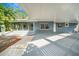 Home exterior featuring a covered patio area with concrete flooring at 1625 Fulton Ave, Clearwater, FL 33755