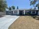 Charming single-story home showcasing a freshly painted exterior and a well-manicured lawn at 1625 Fulton Ave, Clearwater, FL 33755