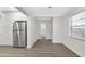 A bright kitchen area featuring stainless steel refrigerator and luxury vinyl plank flooring at 1625 Fulton Ave, Clearwater, FL 33755