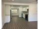 Open-concept kitchen featuring modern white cabinets, stainless steel appliances, and a cozy breakfast bar at 1625 Fulton Ave, Clearwater, FL 33755