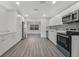 Well-lit kitchen featuring stainless appliances, white cabinets, and modern backsplash at 1625 Fulton Ave, Clearwater, FL 33755