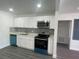 Bright kitchen featuring white cabinets, stainless steel appliances, and stylish backsplash at 1625 Fulton Ave, Clearwater, FL 33755