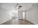 Living room with modern gray floors and white walls with views to the bright kitchenette at 1625 Fulton Ave, Clearwater, FL 33755