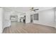 Spacious living area with sleek flooring, open floor plan, and view into the modern kitchen at 1625 Fulton Ave, Clearwater, FL 33755