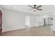 Bright living room with updated flooring, ceiling fan, and open access to other areas of the home at 1625 Fulton Ave, Clearwater, FL 33755