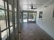 Bright sunroom with tiled floor, large glass windows and a ceiling fan at 1625 Fulton Ave, Clearwater, FL 33755
