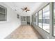Bright sunroom featuring tile flooring, a ceiling fan, and sliding glass doors to seamlessly connect the indoors with the outdoors at 1625 Fulton Ave, Clearwater, FL 33755