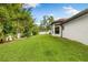 View of the home's exterior and backyard, with a well-manicured lawn at 17347 Linda Vista Cir, Lutz, FL 33548