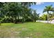 Large backyard featuring a grassy area, trees, and white fencing at 17347 Linda Vista Cir, Lutz, FL 33548