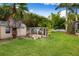 Backyard featuring chicken coop, storage shed, and lots of greenery at 17347 Linda Vista Cir, Lutz, FL 33548