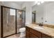 Modern bathroom featuring a glass enclosed shower, granite counter, and wood vanity at 17347 Linda Vista Cir, Lutz, FL 33548