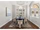 Formal dining room with hardwood floors, chandelier, dark wood table, and cream colored upholstered chairs at 17347 Linda Vista Cir, Lutz, FL 33548