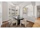 Formal dining room with hardwood floors, chandelier, dark wood table, cream colored upholstered chairs at 17347 Linda Vista Cir, Lutz, FL 33548
