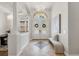 Elegant foyer with a chandelier, arched transom window over a glass double-door, and a bench at 17347 Linda Vista Cir, Lutz, FL 33548